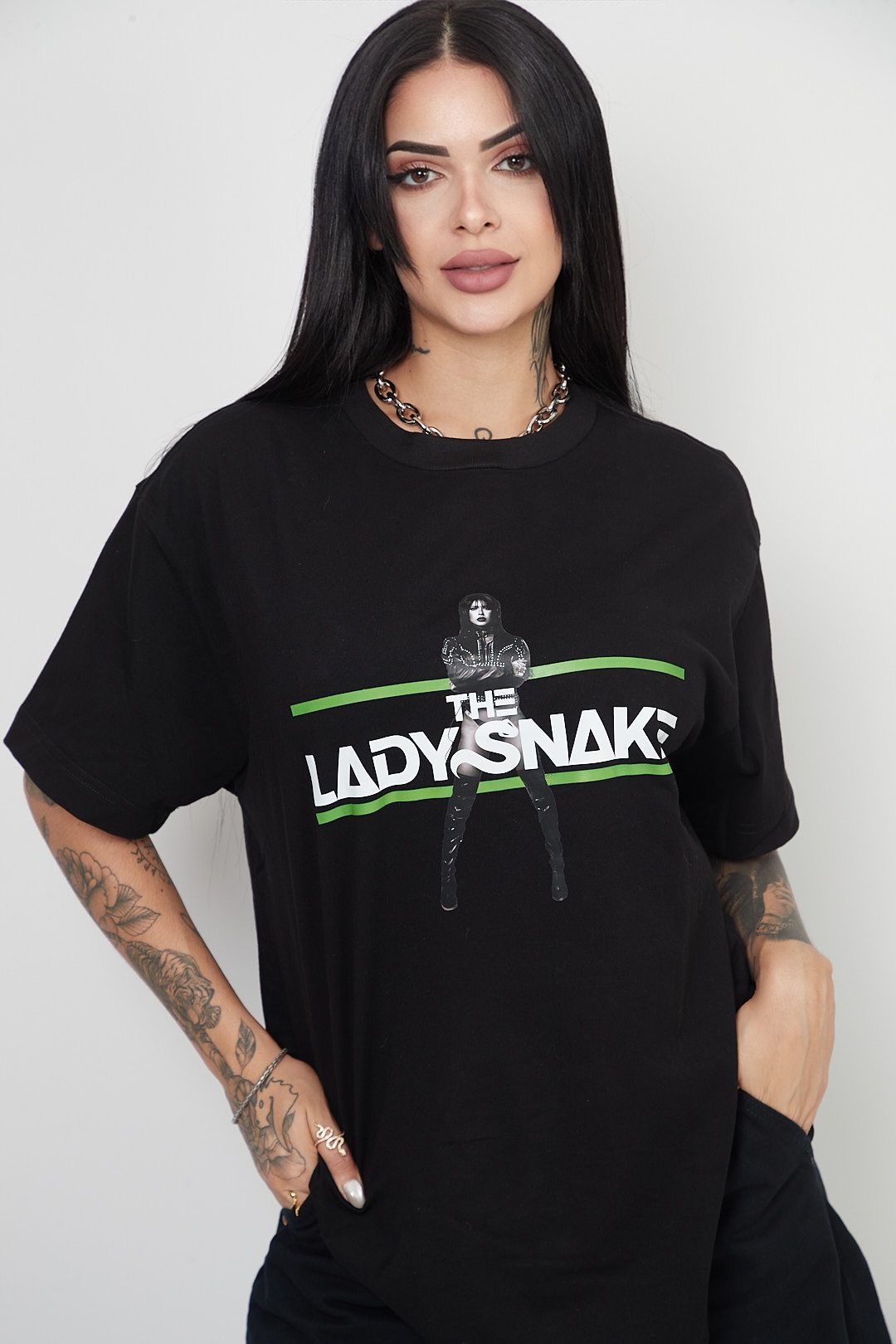 Black oversize tee with The Lady Snake logo in green